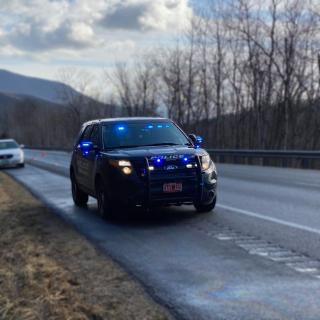 Castleton PD Cruiser on highway with emergency lights, blurred background