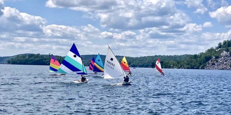 The Sail Camp Fleet off Cedar Mountain and Neshobe Island. The Sail Camp Fleet off Cedar Mountain and Neshobe Island.